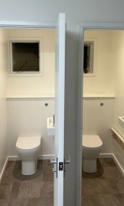 Two refurbished, modern toilet cubicles.
